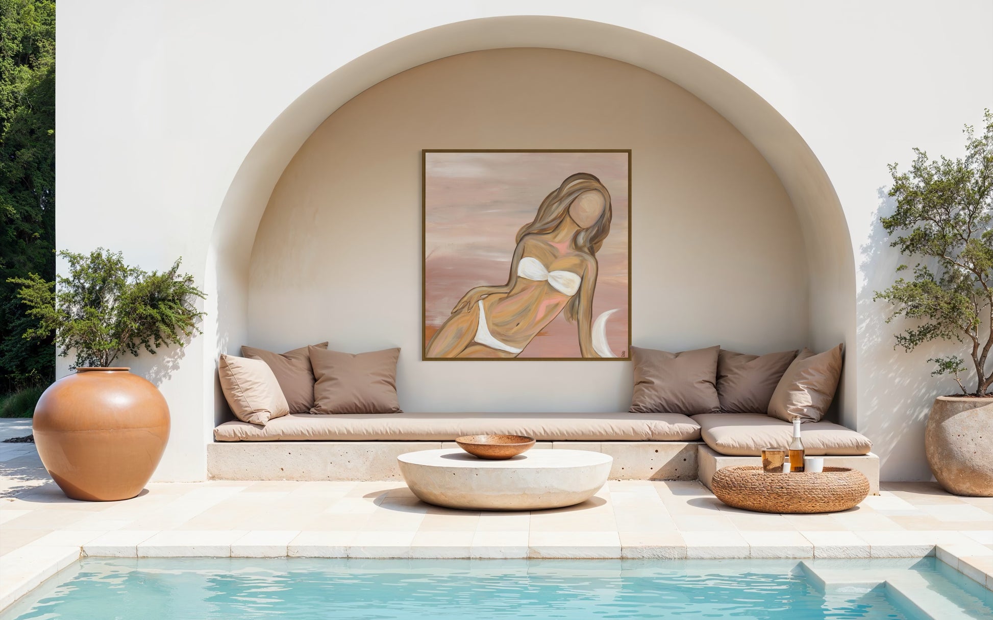 Outdoor seating area with a pool, decorative wall art, and potted plants.